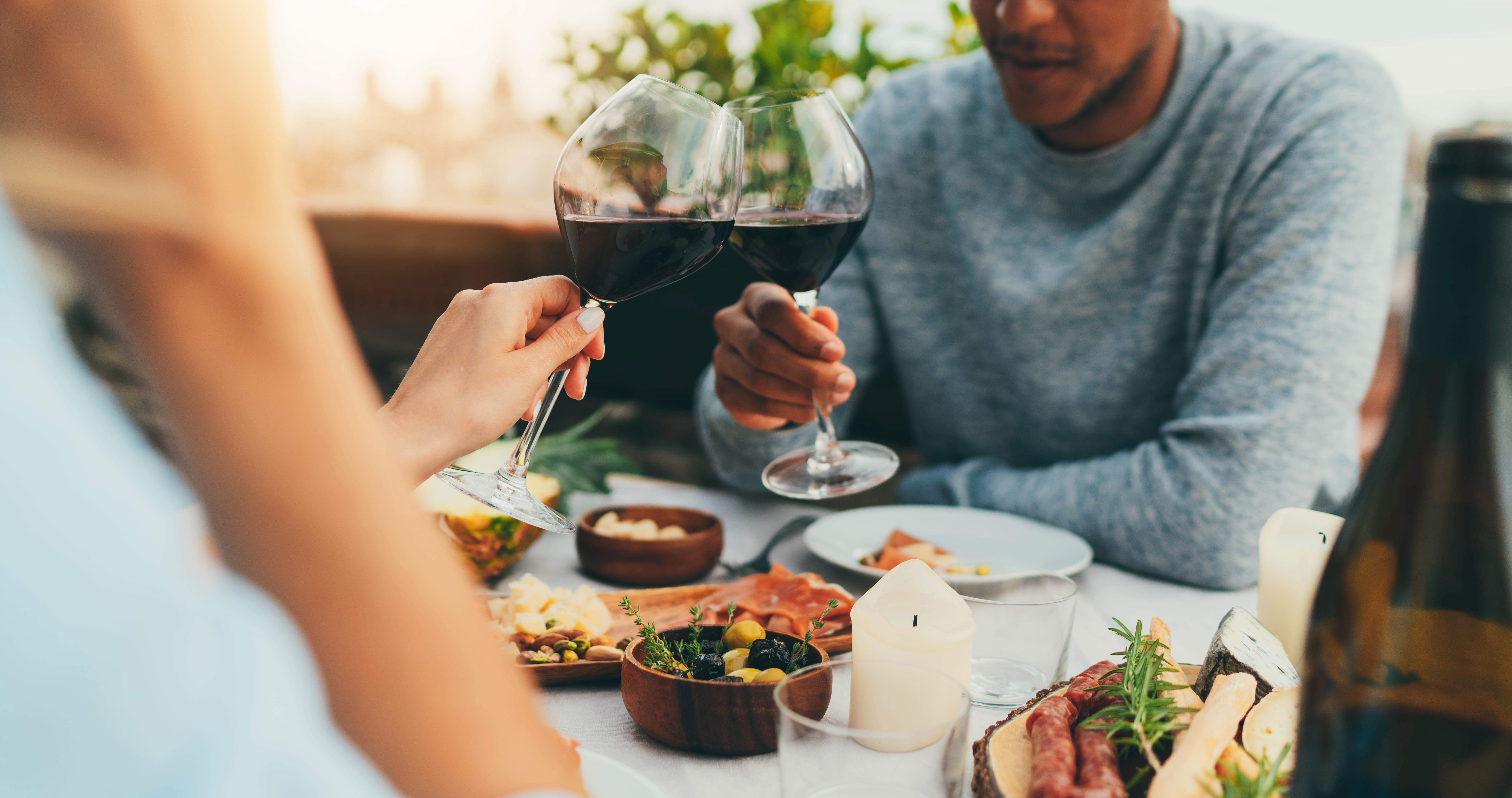 Couple,Enjoying,Romantic,Dinner,At,Restaurant,Terrace,Drinking,Red,Wine