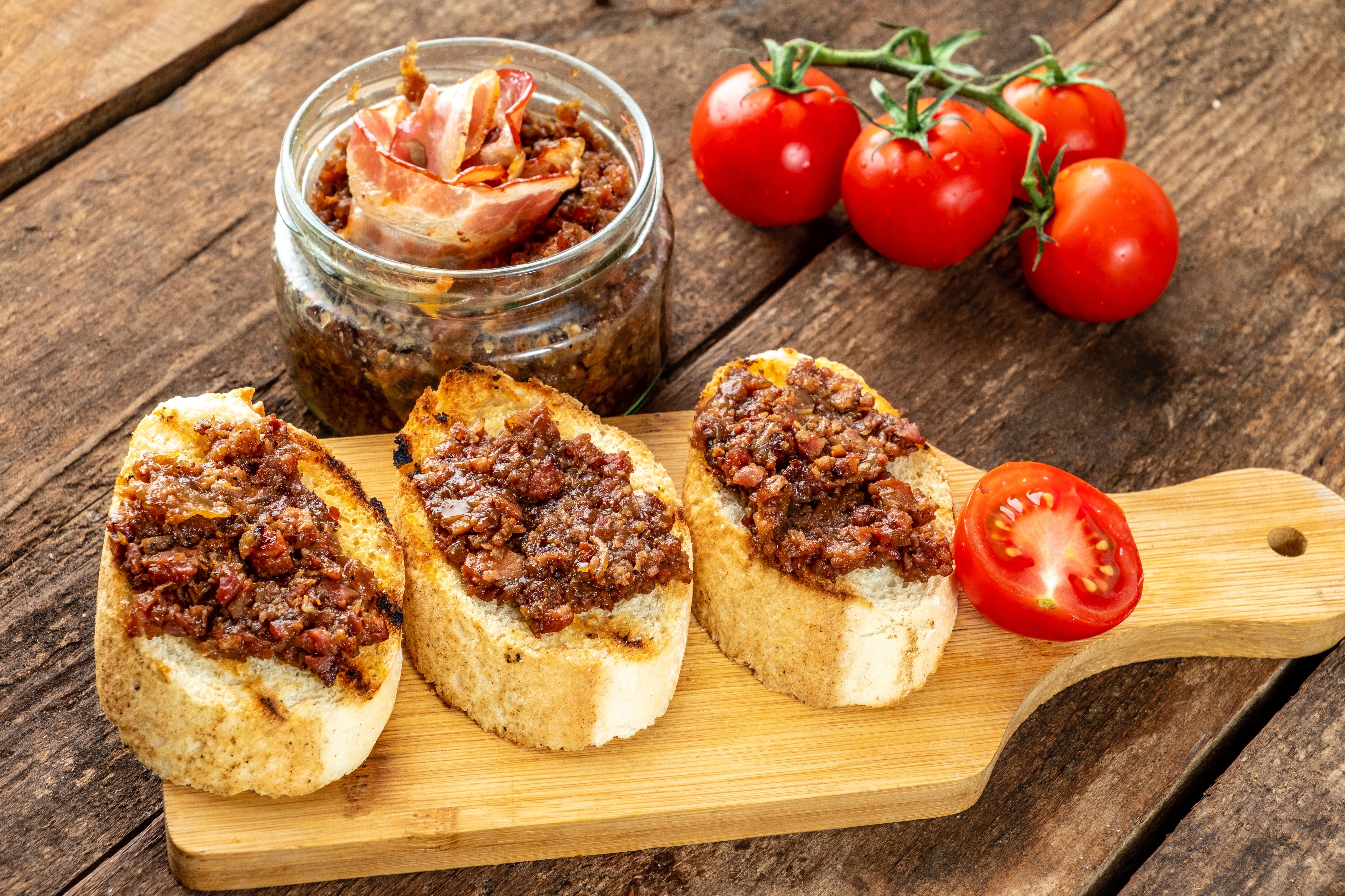 Baguette,With,Bacon,Jam,On,A,Wooden,Table.