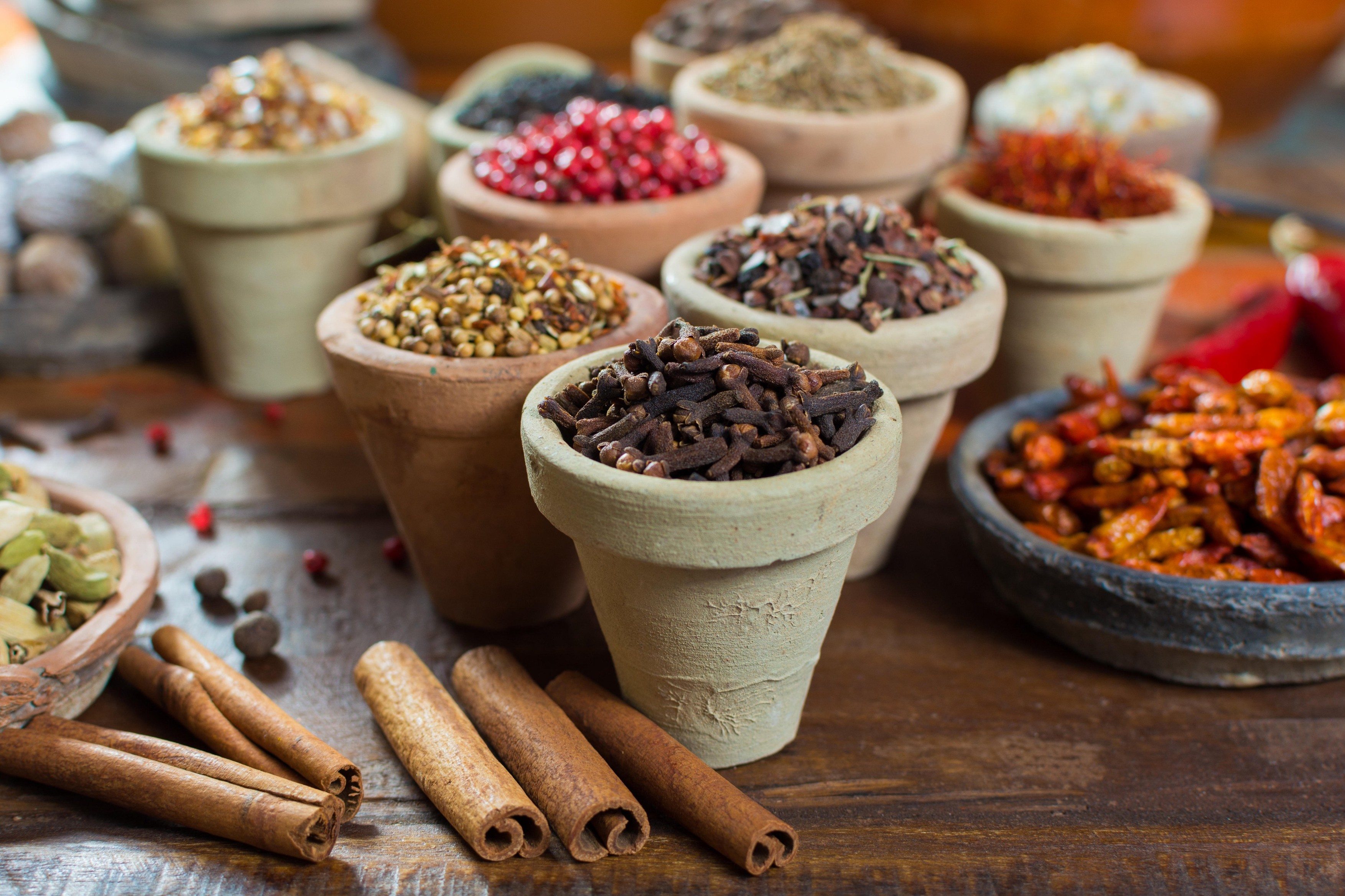 Variety of different asian and middle east spices, colorful assortment, on old wooden table, close up