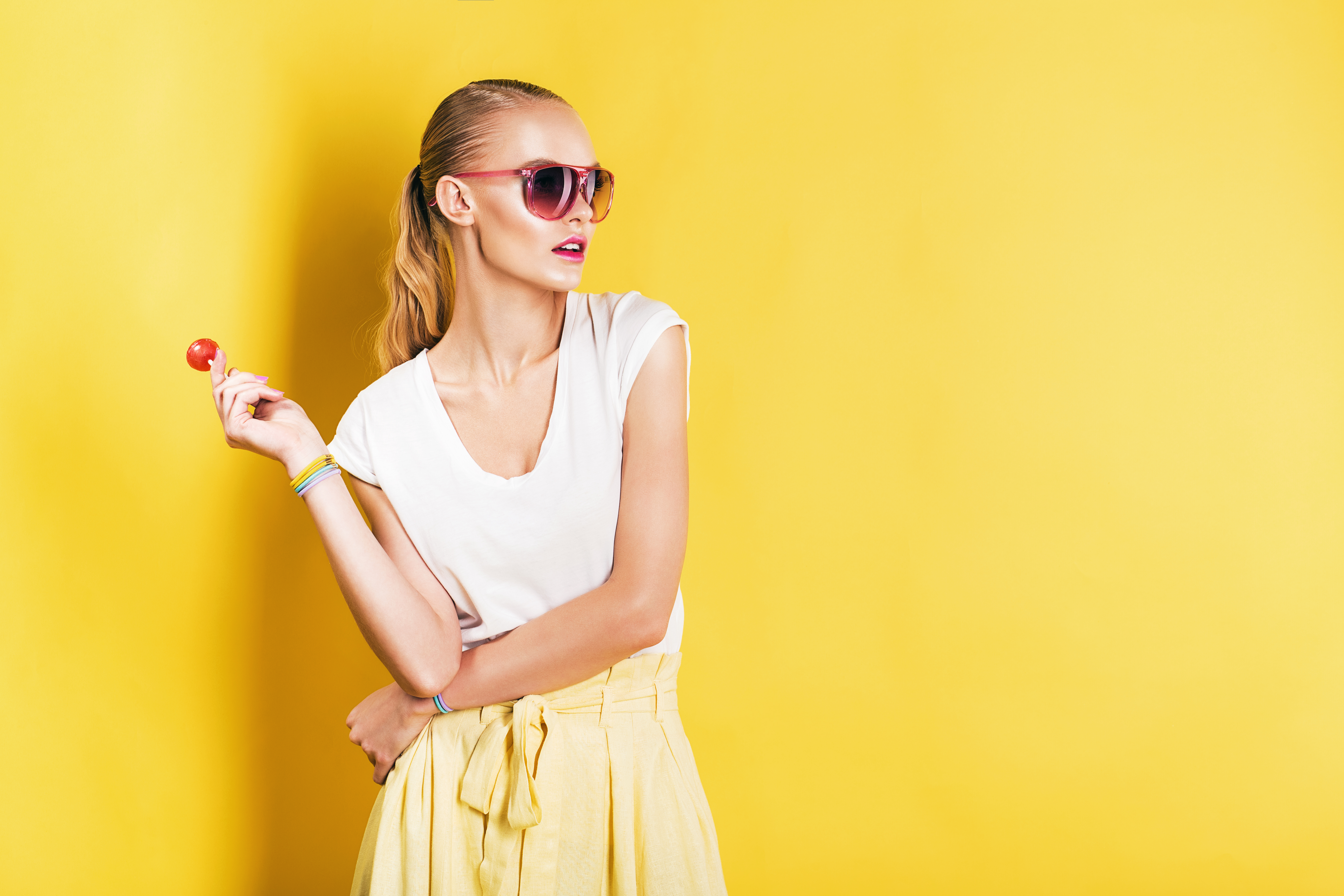 Attractive,Woman,In,White,Top,With,Lollipop,In,Hand,On