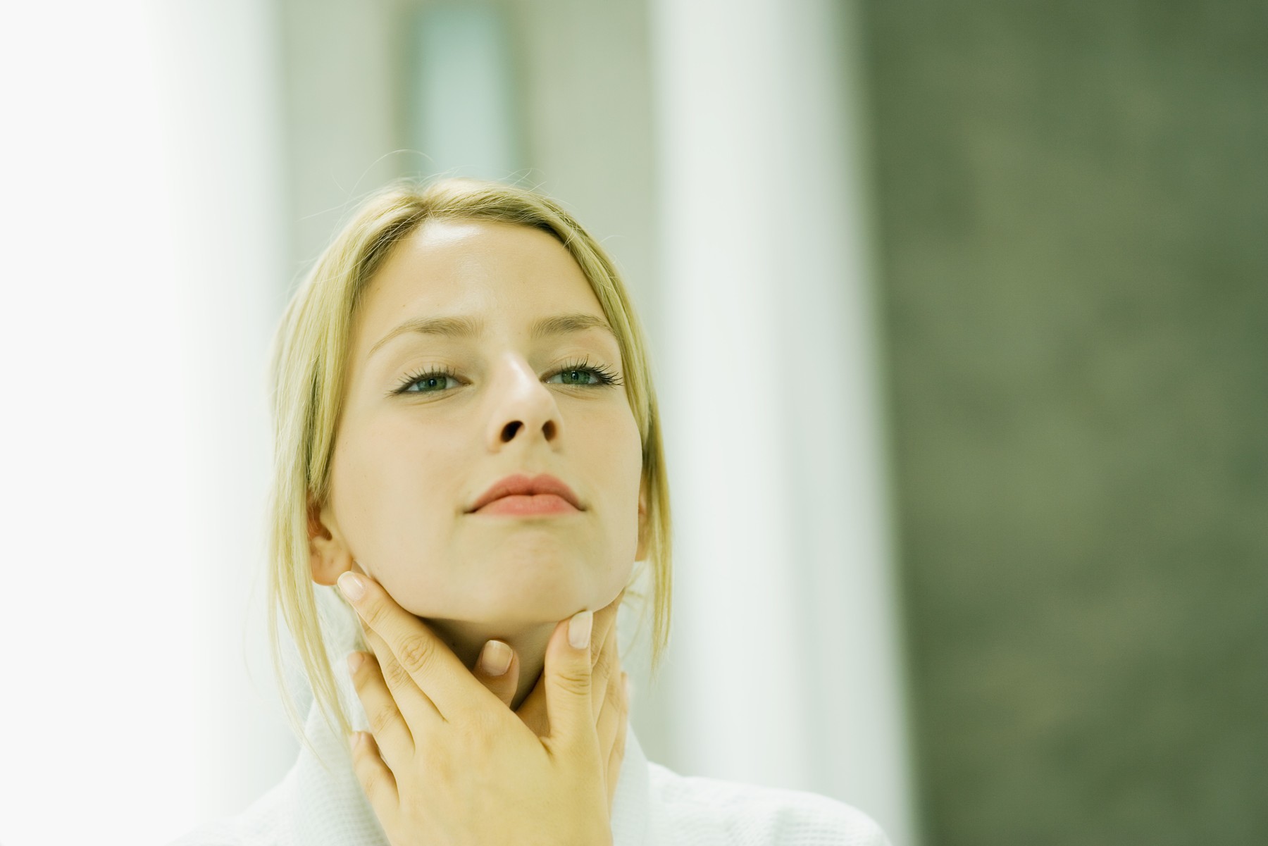 Woman touching her neck