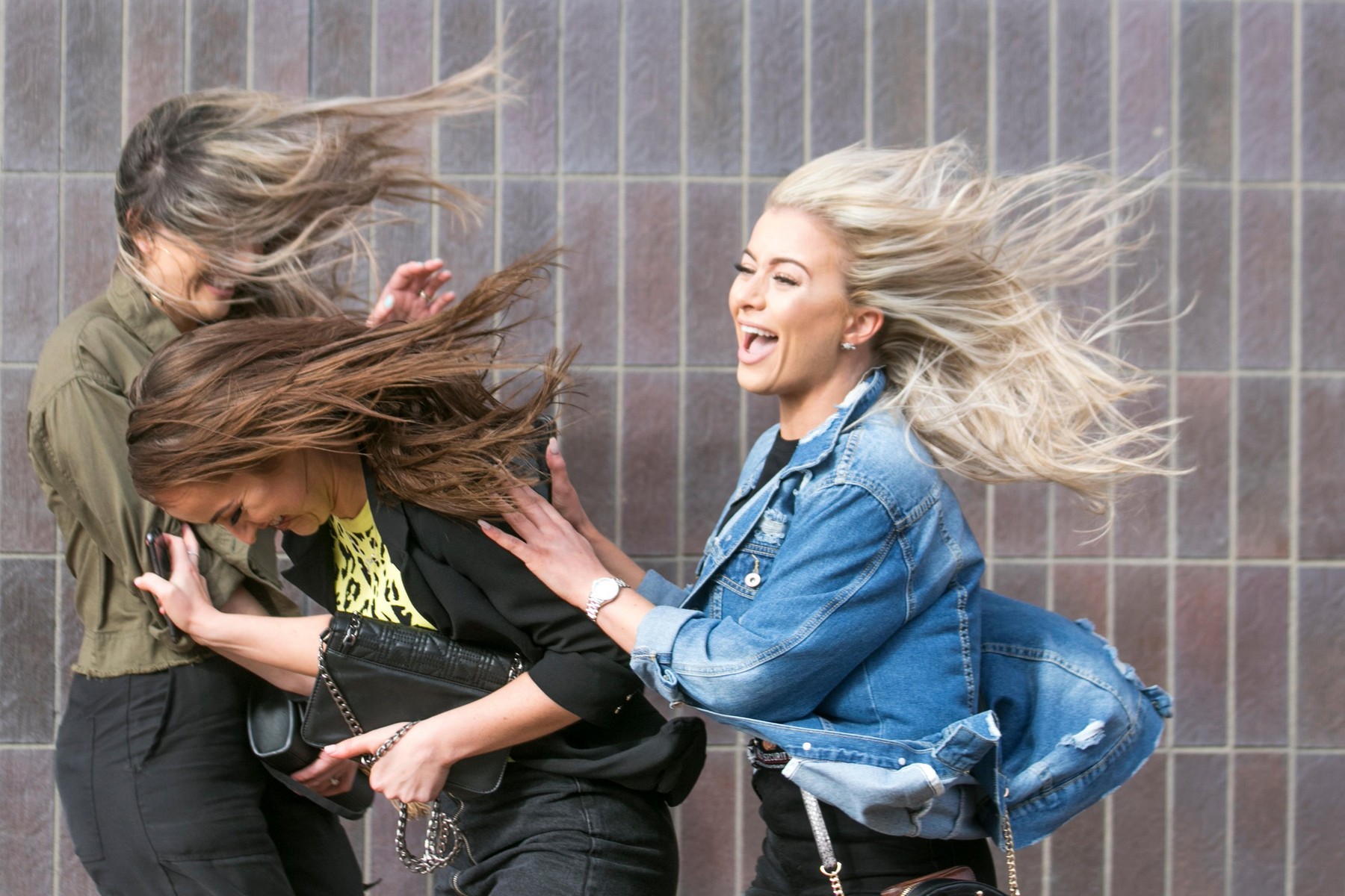 Blackpool, Lancashire, UK. 10th March, 2019. Strong gale force winds at the coast. Tracy, Sharon aand Carol are windswept as the strong blustery winds sweep through the town centre. Weather warnings have been issued over the north west of England for seve