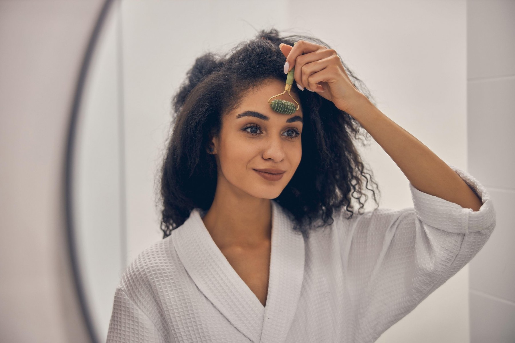 Good-looking girl giving herself a facial massage