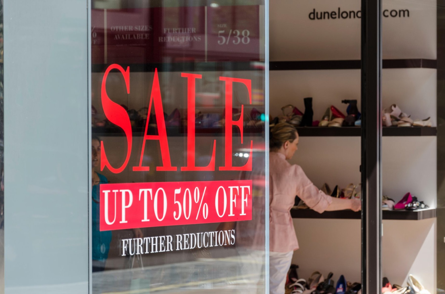 Sale window decal on a Dune shoe store, Oxford Street, London, UK