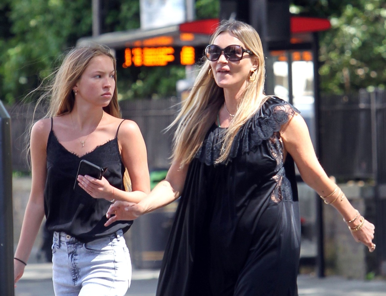*EXCLUSIVE* British supermodel Kate Moss pictured looking effortlessly stylish in a black summerry dress as she's seen with her daughter Lila Grace Moss in London.
