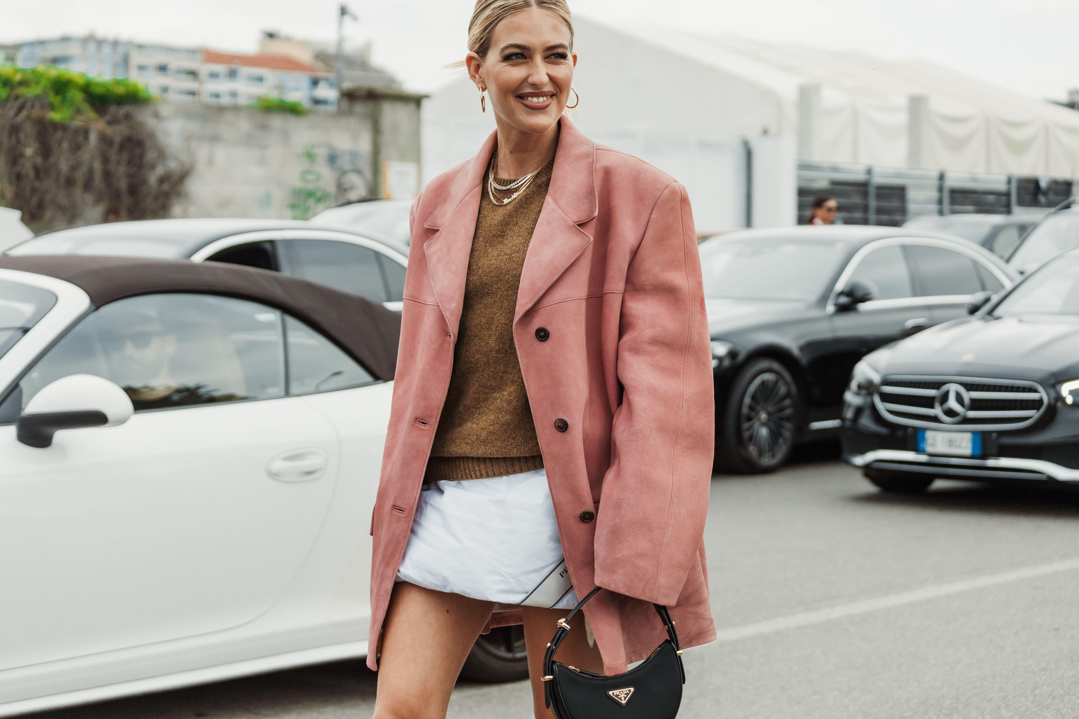 Emili Sindlev wears necklaces, a knit pullover