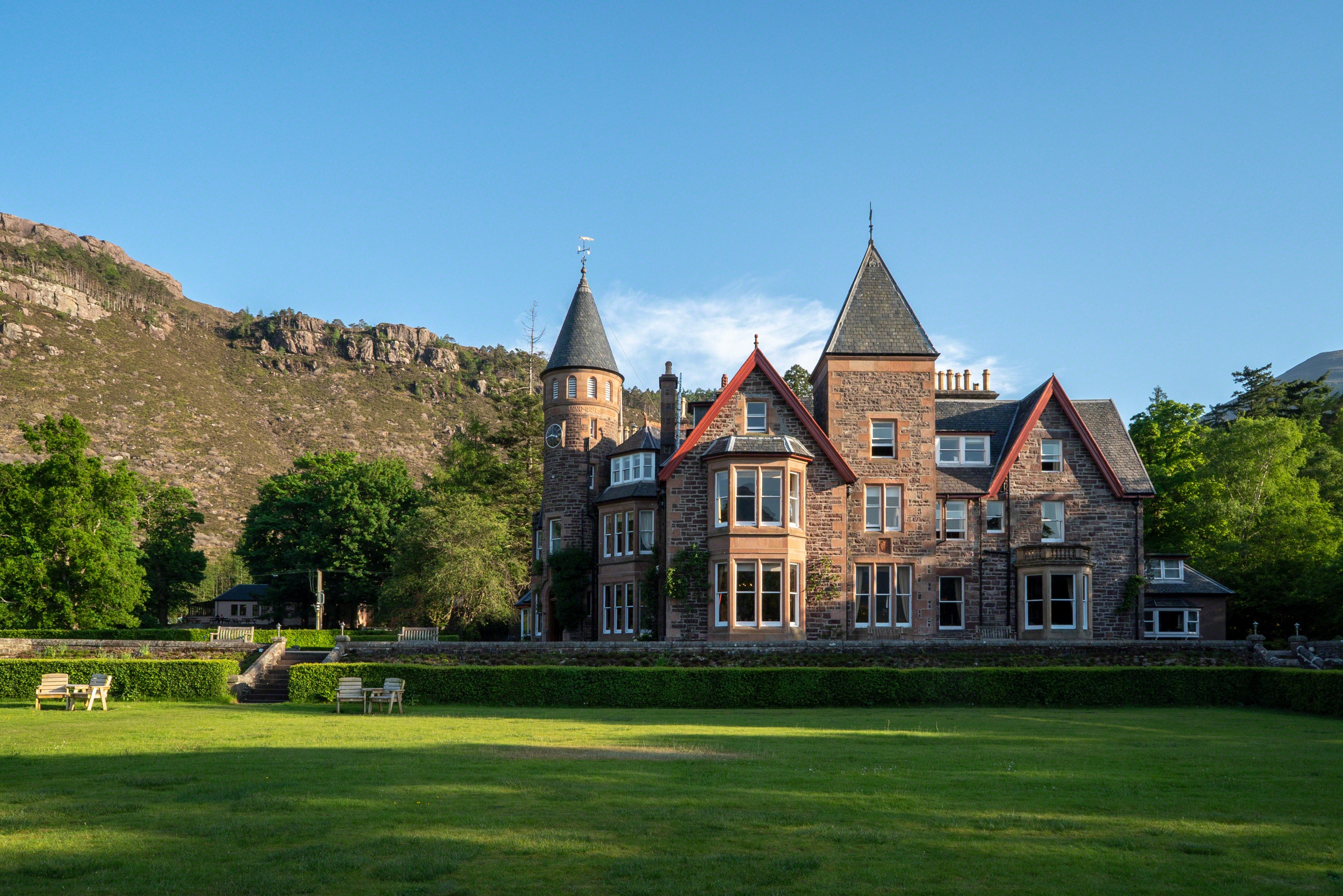 A grand Victorian hotel with a conical turret, set in a glacially