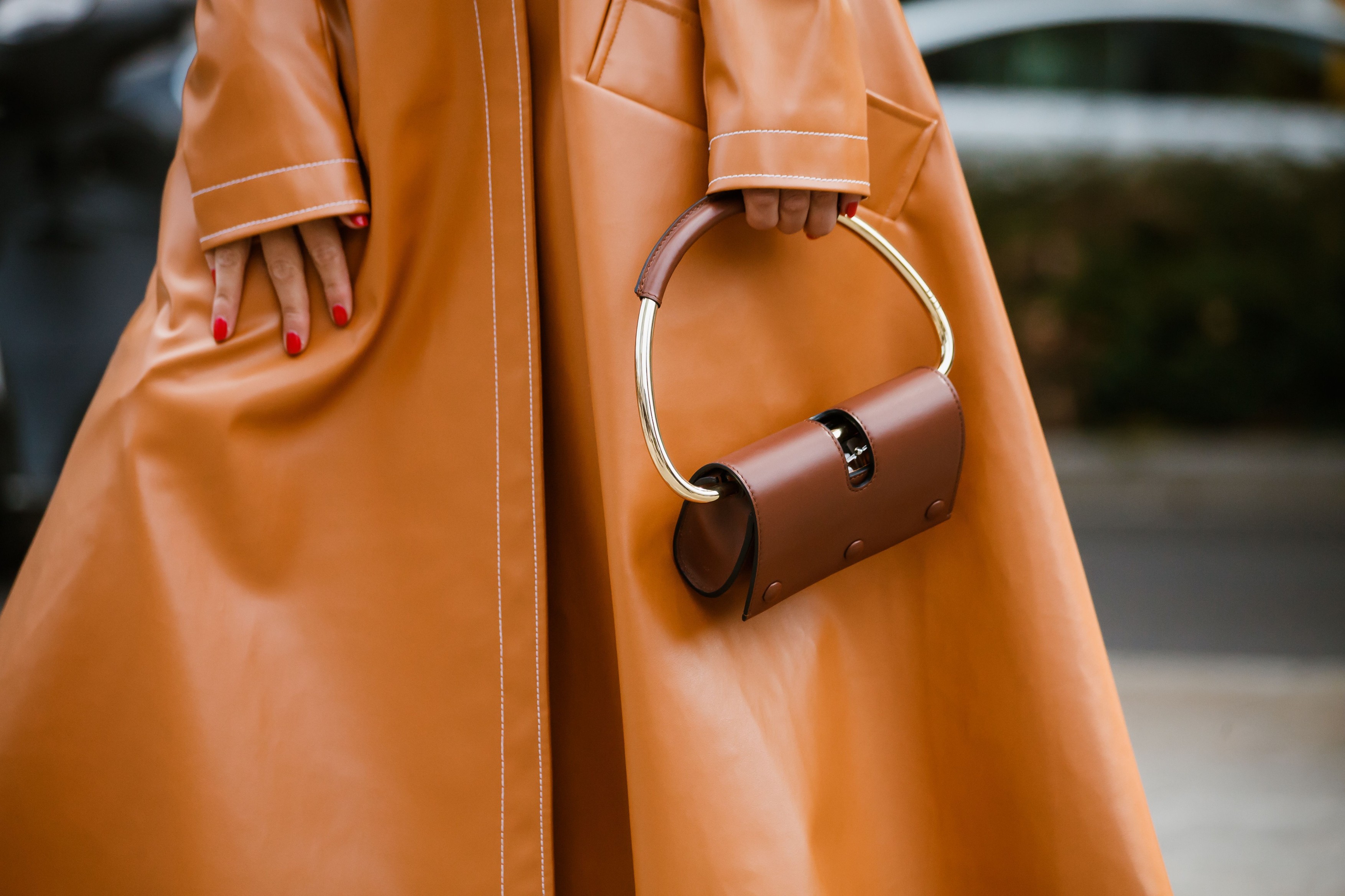 Bettina Looney wears, an orange leather coat